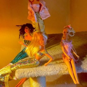 Eight gently used Barbies plus extra outfits!